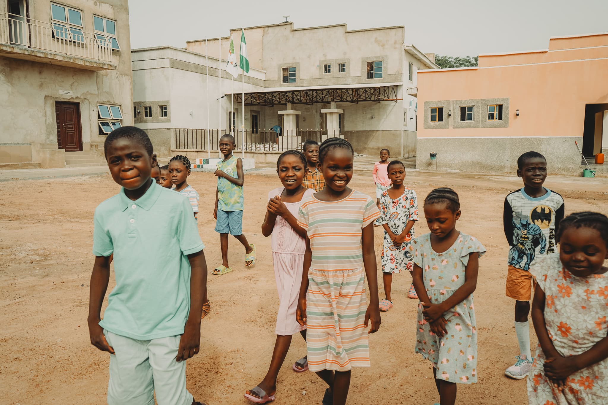 Smiling children in a schoolyard in Nigeria
