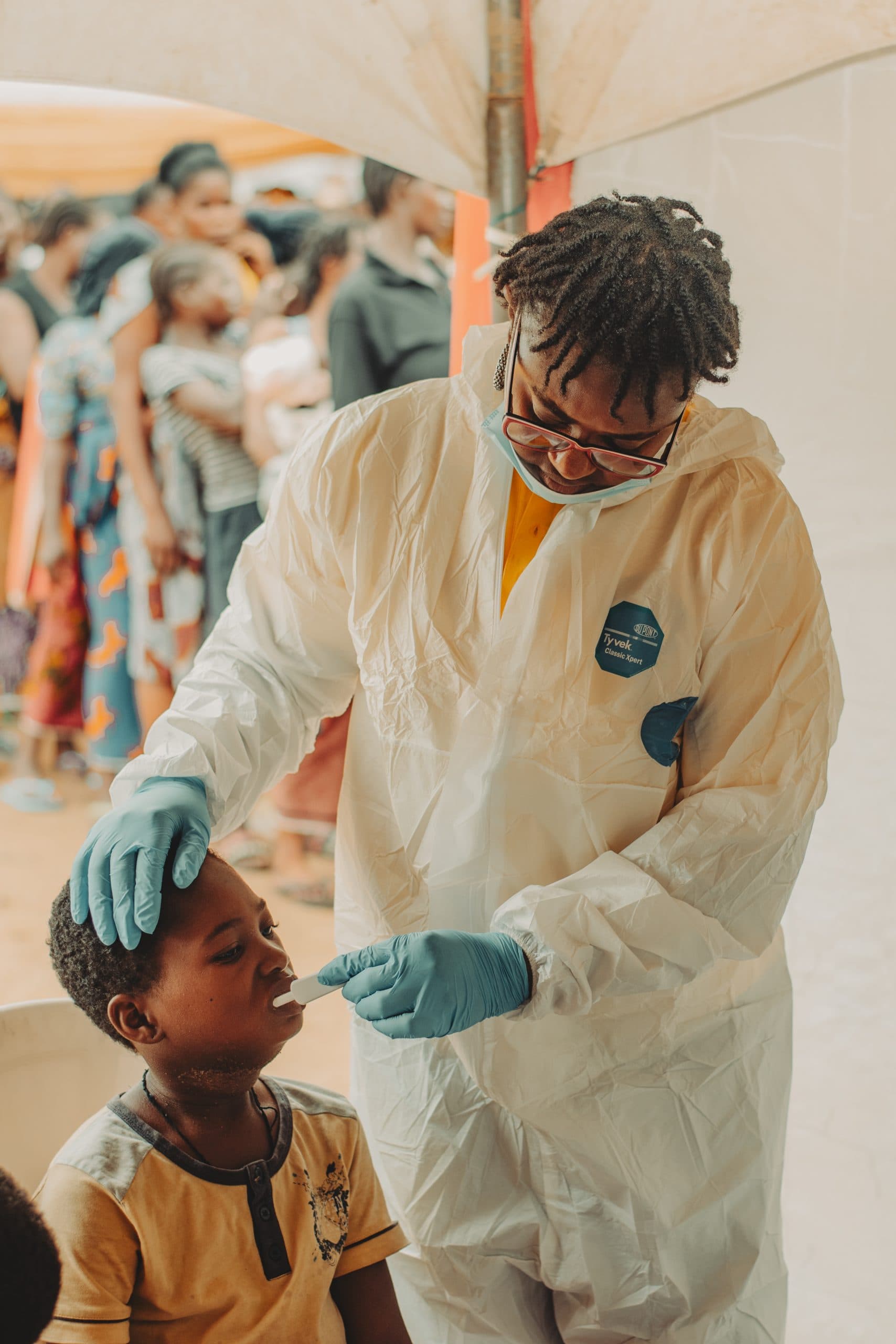 A medical volunteer examining a young boy