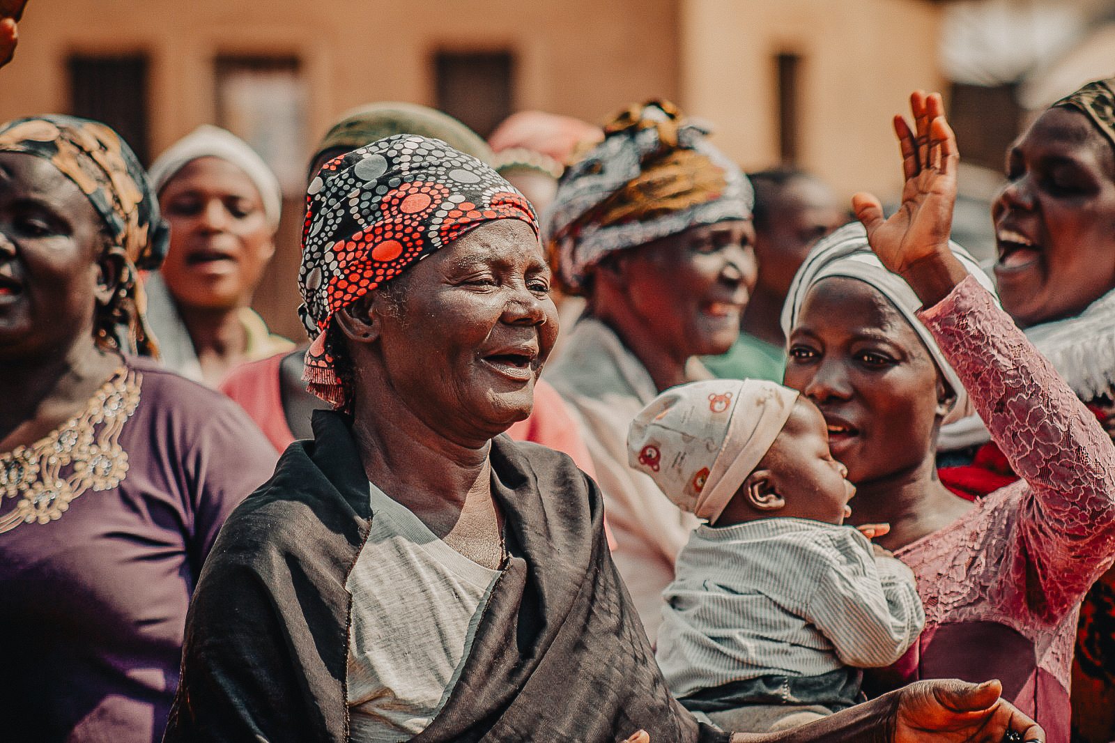 Women laughing and celebrating together at a gathering in Nigeria
