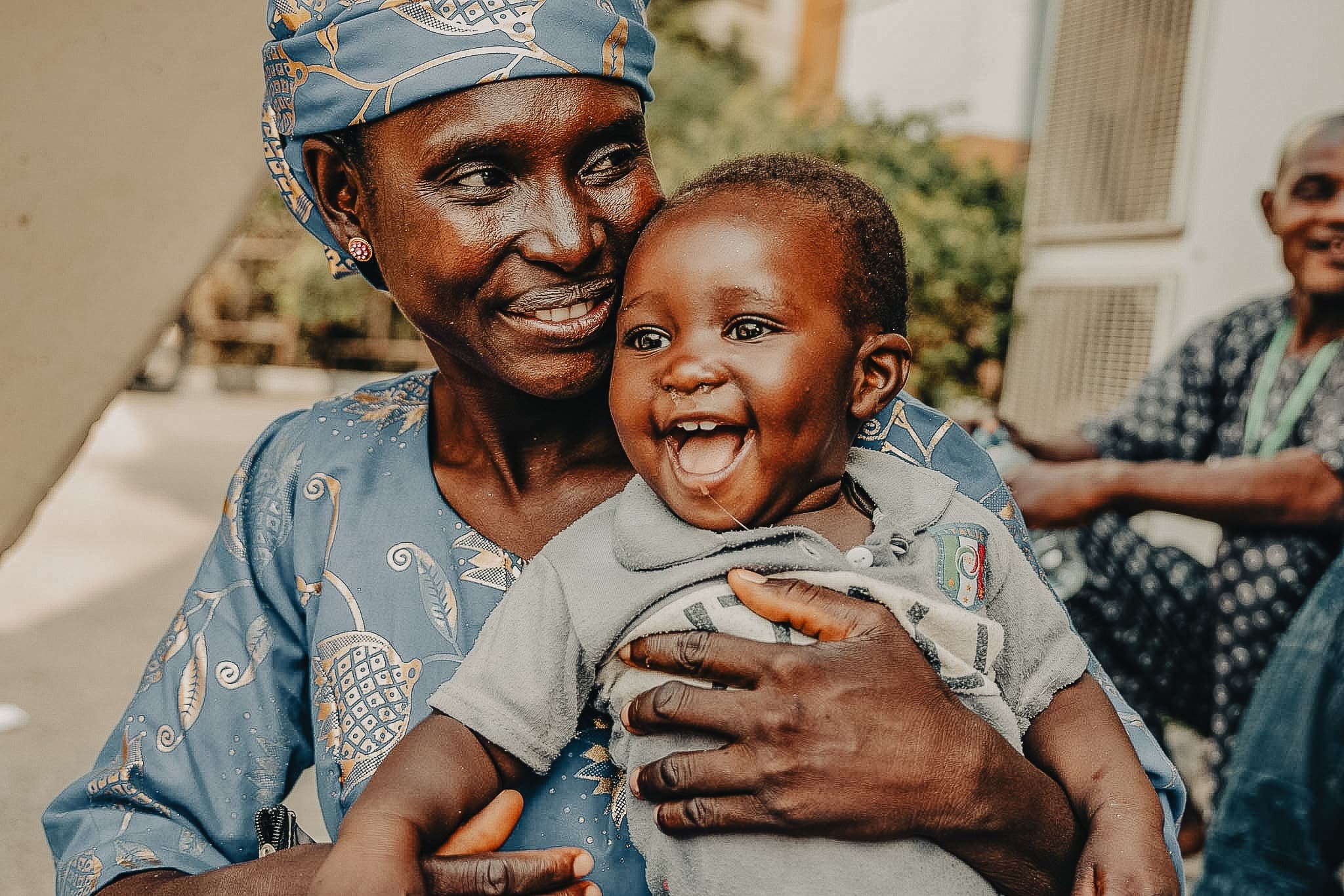 A smiling woman holding a laughing baby